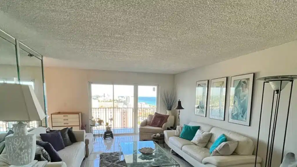 A spacious living room featuring a popcorn ceiling