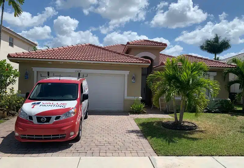 Home exterior with Value Painting and Flooring service truck on the driveway