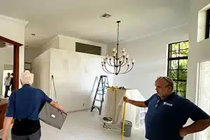 Value Painting and Flooring workers assessing area for popcorn ceiling removal