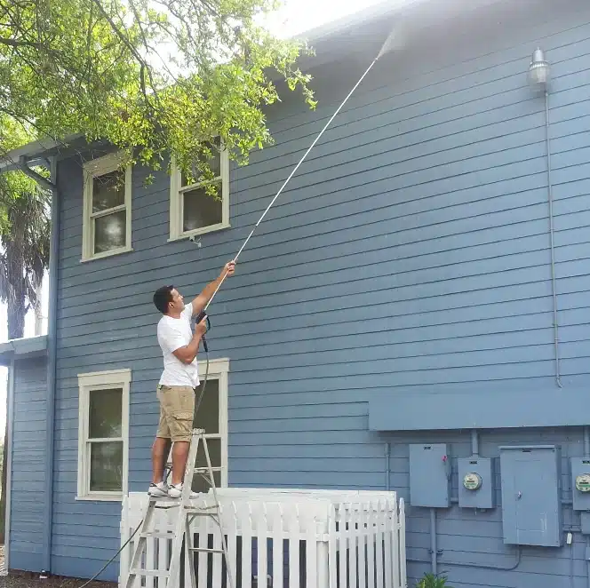 Mario, CEO of Value Painting and Flooring, engaged in power washing service.