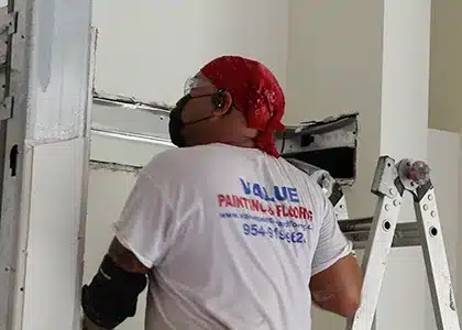 Worker inspecting walls before interior house painting.