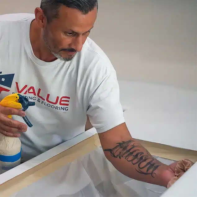 Value Painting and Flooring worker cleaning an epoxy countertop