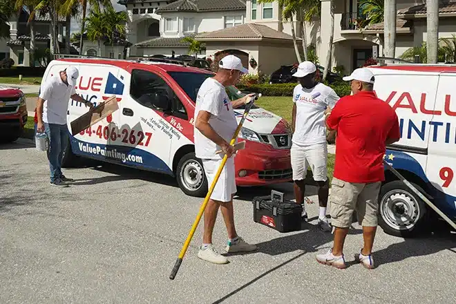 Value Painting and Flooring workers preparing for a paint job.