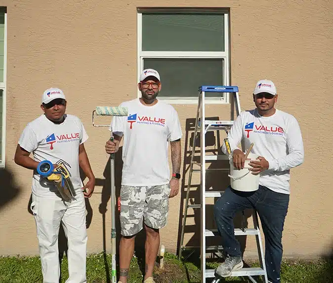 Value Painting and Flooring team members posing for a photo