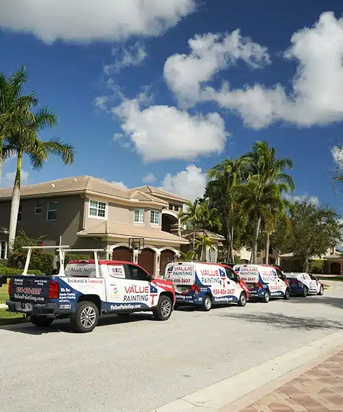 Value Painting & Flooring service trucks in front of a Florida home