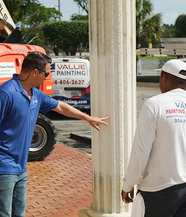 Mario from Value Painting and Flooring checking quality at a commercial site