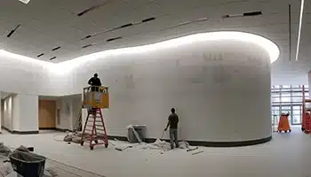 Interior of a commercial building during wallpaper removal by Value Painting and Flooring