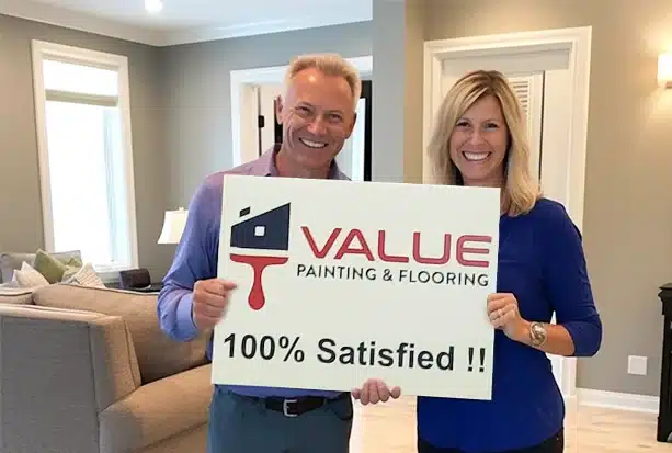 Two happy elderly customers holding a "100% satisfied" sign.