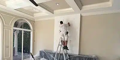 Value Painting worker repairing drywall.