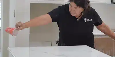 Value Painting worker pouring epoxy on a countertop.