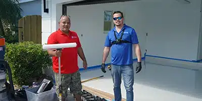 Mario and a team member prepping for an epoxy garage flooring project.