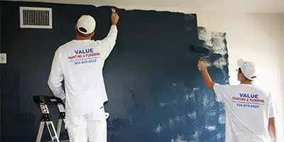 Value Painting and Flooring workers painting an interior.