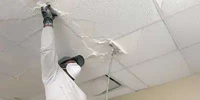 Value Painting worker removing popcorn from a ceiling.