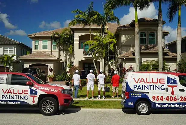 Value Painting and Flooring workers posing in front of a South Florida home.